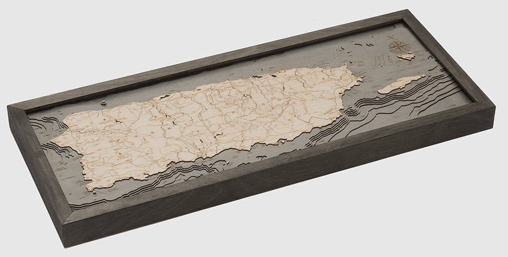 Puerto Rico 3D layered wood map in laser-cut Baltic birch, shown framed against a light wall