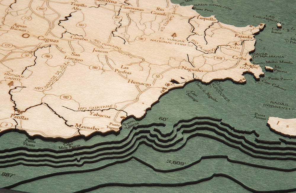 Puerto Rico 3D layered wood map in laser-cut Baltic birch, shown framed against a light wall