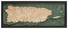 Puerto Rico 3D layered wood map in laser-cut Baltic birch, shown framed against a light wall
