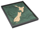 New Zealand 3D layered wood map in laser-cut Baltic birch, shown framed against a light wall