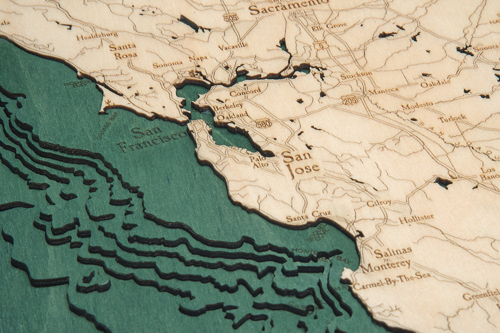 California Coast 3D layered wood map in laser-cut Baltic birch, shown framed against a light wall