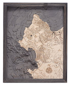 Carmel & Monterey, California 3D layered wood map in laser-cut Baltic birch, shown framed against a light wall