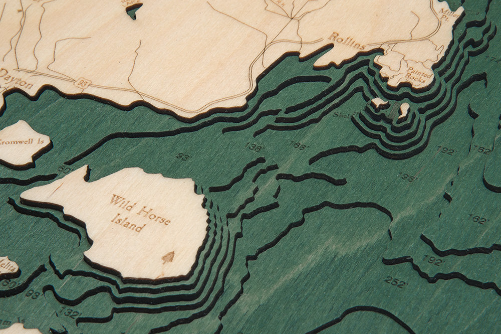 Flathead Lake, Montana 3D layered wood map in laser-cut Baltic birch, shown framed against a light wall