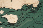 Flathead Lake, Montana 3D layered wood map in laser-cut Baltic birch, shown framed against a light wall
