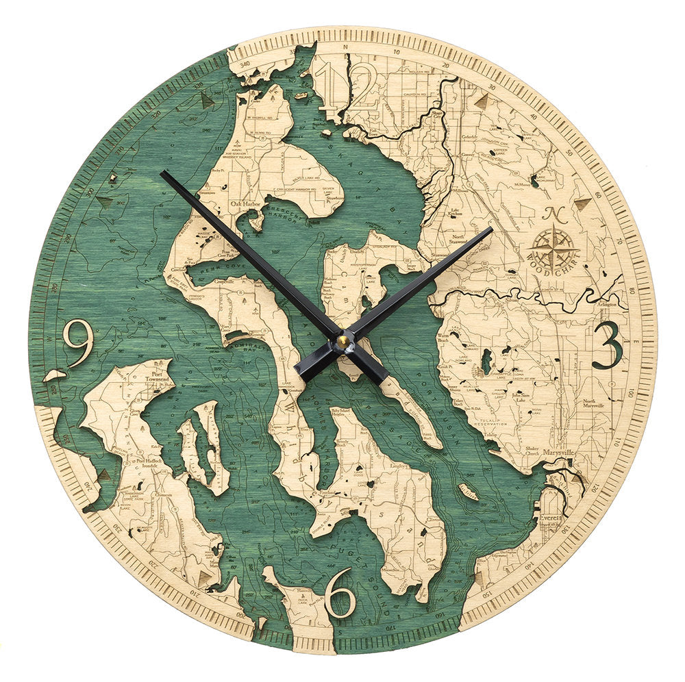 Whidbey & Camano Islands, Washington wood wall clock in laser-cut Baltic birch, shown framed against a light wall
