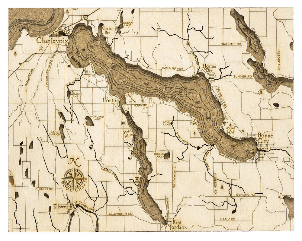 Lake Charlevoix, Michigan framed cork map in laser-cut Baltic birch, shown framed against a light wall