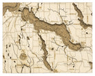 Lake Charlevoix, Michigan framed cork map in laser-cut Baltic birch, shown framed against a light wall