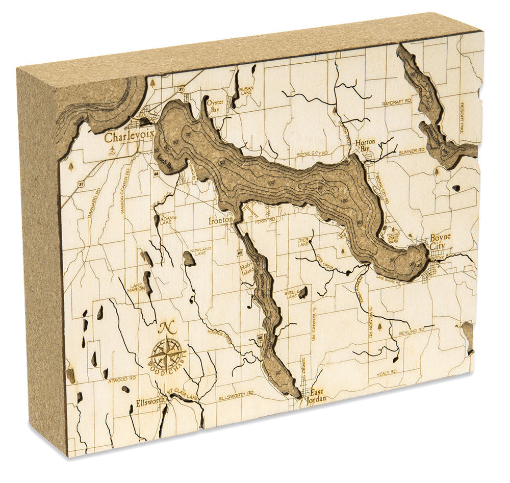 Lake Charlevoix, Michigan framed cork map in laser-cut Baltic birch, shown framed against a light wall