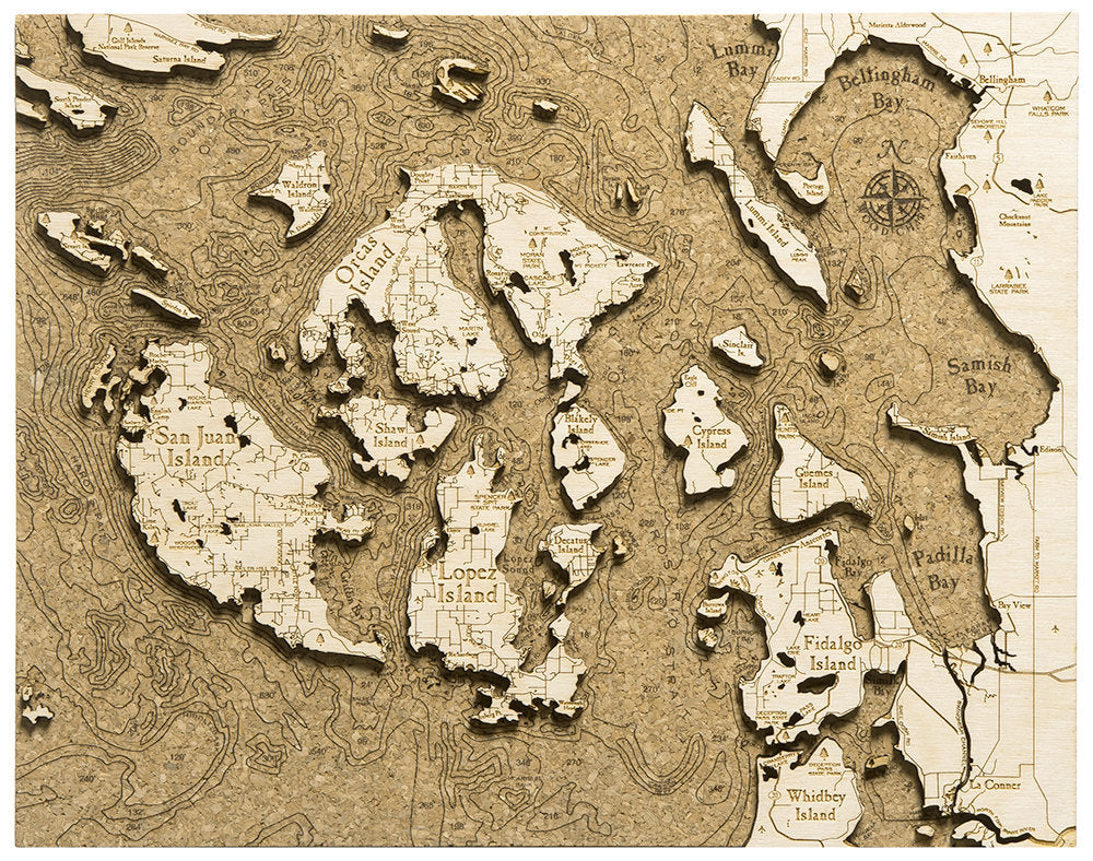 San Juan Islands, Washington framed cork map in laser-cut Baltic birch, shown framed against a light wall