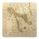 Lake Charlevoix, Michigan wood cribbage board in laser-cut Baltic birch, shown framed against a light wall