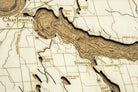Lake Charlevoix, Michigan framed cork map in laser-cut Baltic birch, shown framed against a light wall