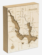 Walloon Lake, Michigan framed cork map in laser-cut Baltic birch, shown framed against a light wall