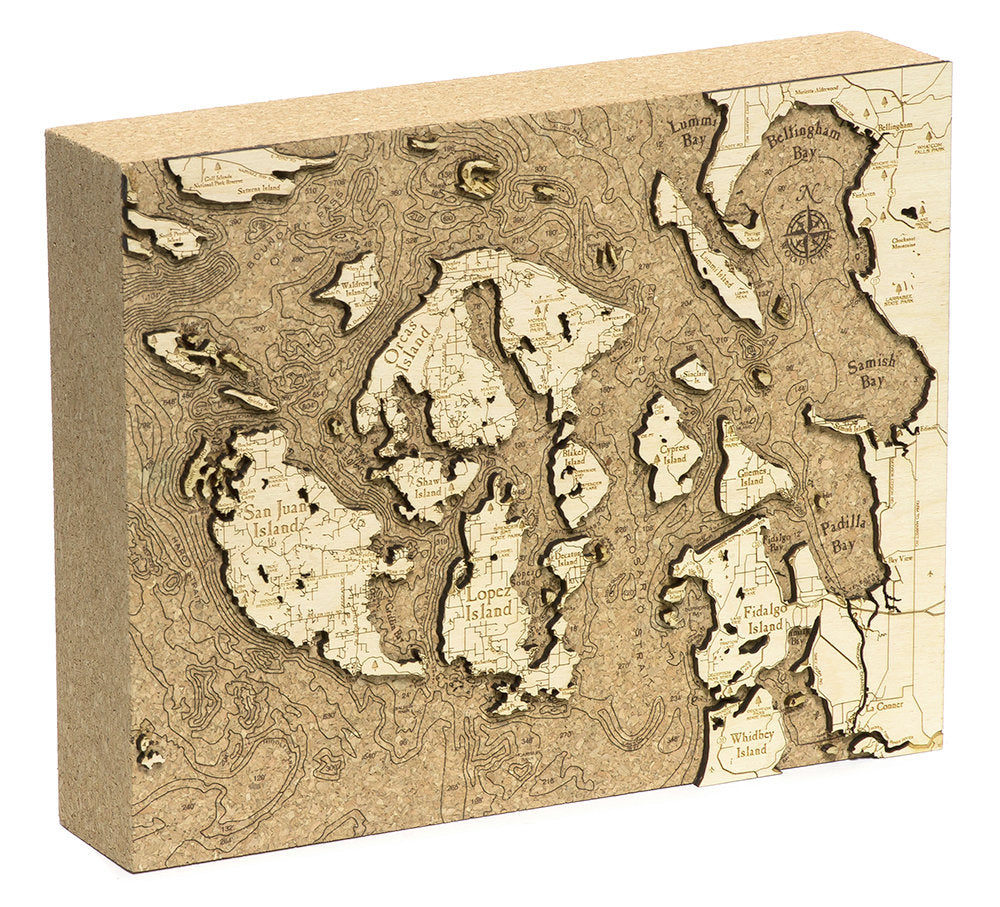 San Juan Islands, Washington framed cork map in laser-cut Baltic birch, shown framed against a light wall