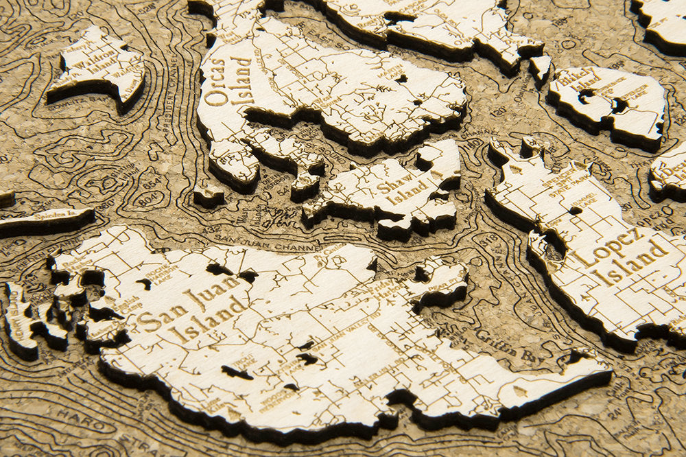 San Juan Islands, Washington framed cork map in laser-cut Baltic birch, shown framed against a light wall