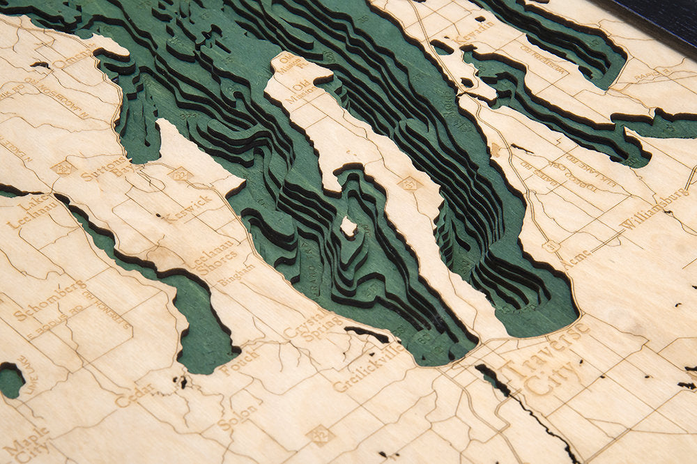 M-22, Michigan 3D layered wood map in laser-cut Baltic birch, shown framed against a light wall
