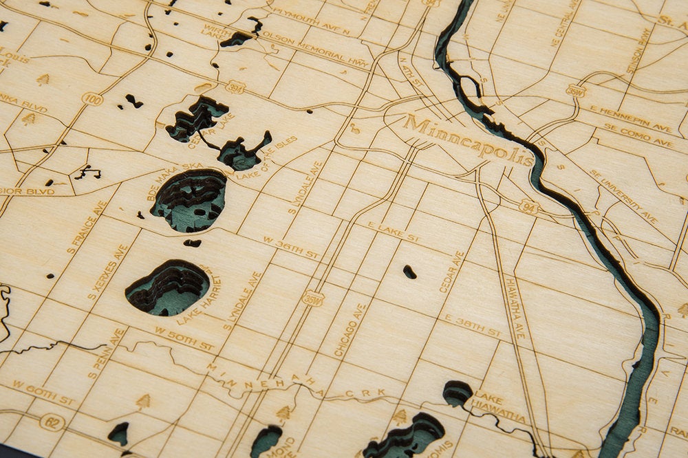 Minneapolis & St. Paul, Minnesota 3D layered wood map in laser-cut Baltic birch, shown framed against a light wall