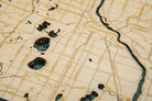 Minneapolis & St. Paul, Minnesota 3D layered wood map in laser-cut Baltic birch, shown framed against a light wall