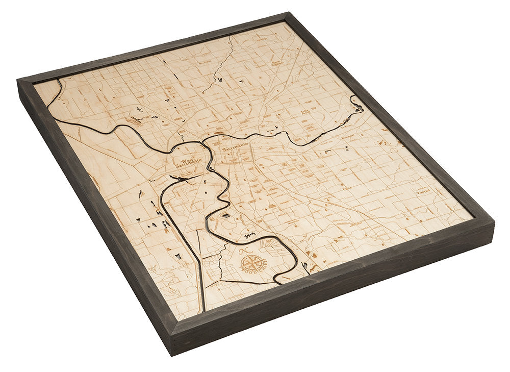 Sacramento, California 3D layered wood map in laser-cut Baltic birch, shown framed against a light wall