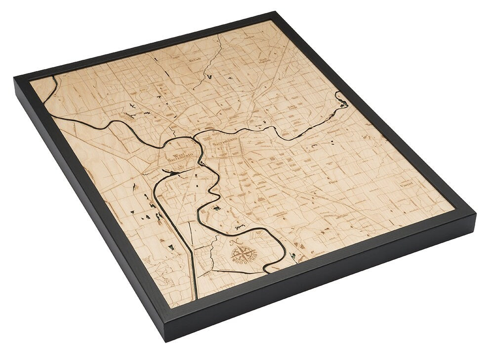 Sacramento, California 3D layered wood map in laser-cut Baltic birch, shown framed against a light wall