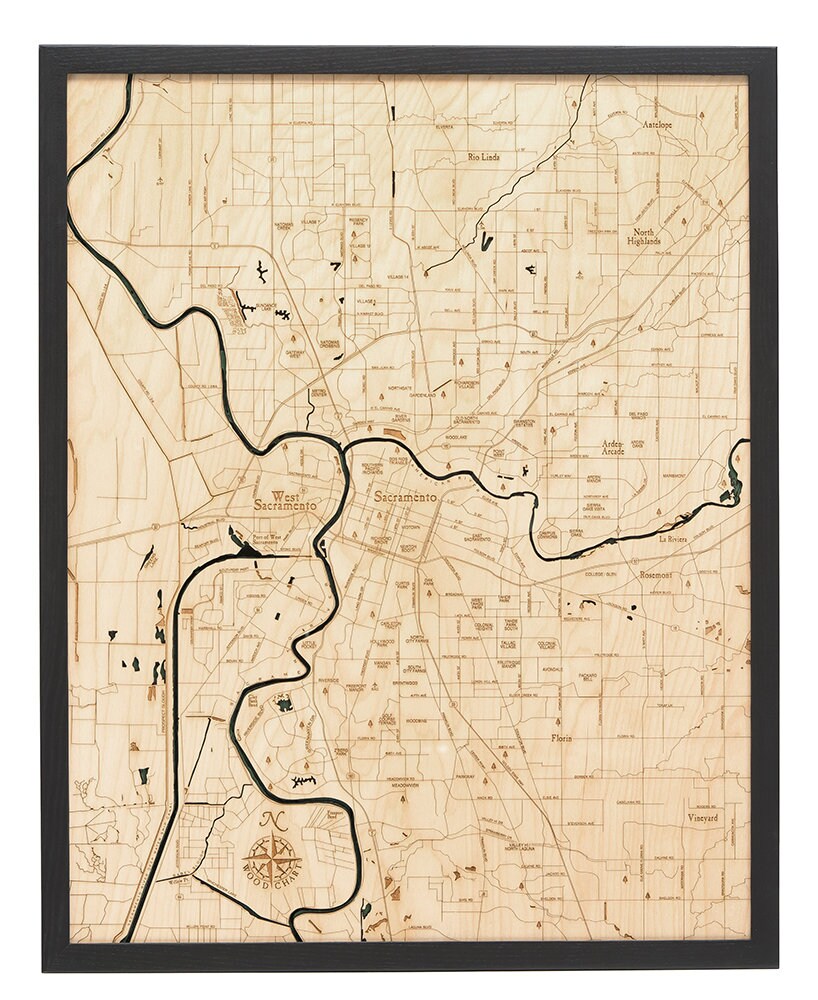 Sacramento, California 3D layered wood map in laser-cut Baltic birch, shown framed against a light wall