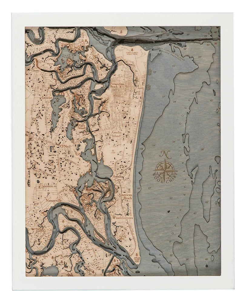 Amelia Island, Florida 3D layered wood map in laser-cut Baltic birch, shown framed against a light wall