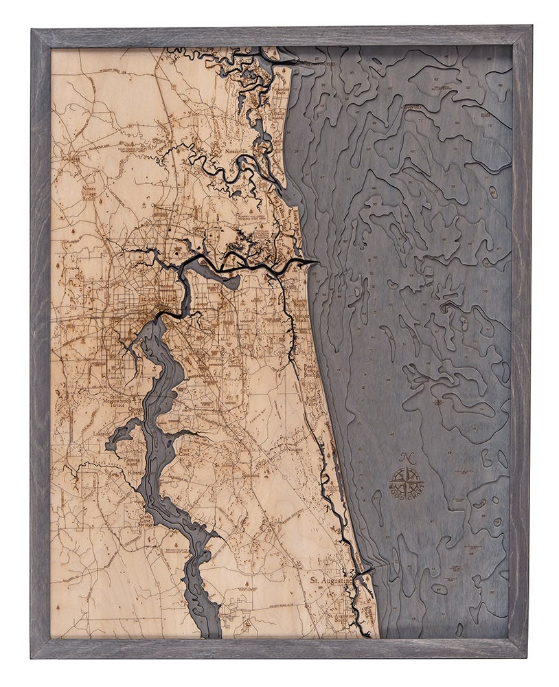 Jacksonville, Florida 3D layered wood map in laser-cut Baltic birch, shown framed against a light wall
