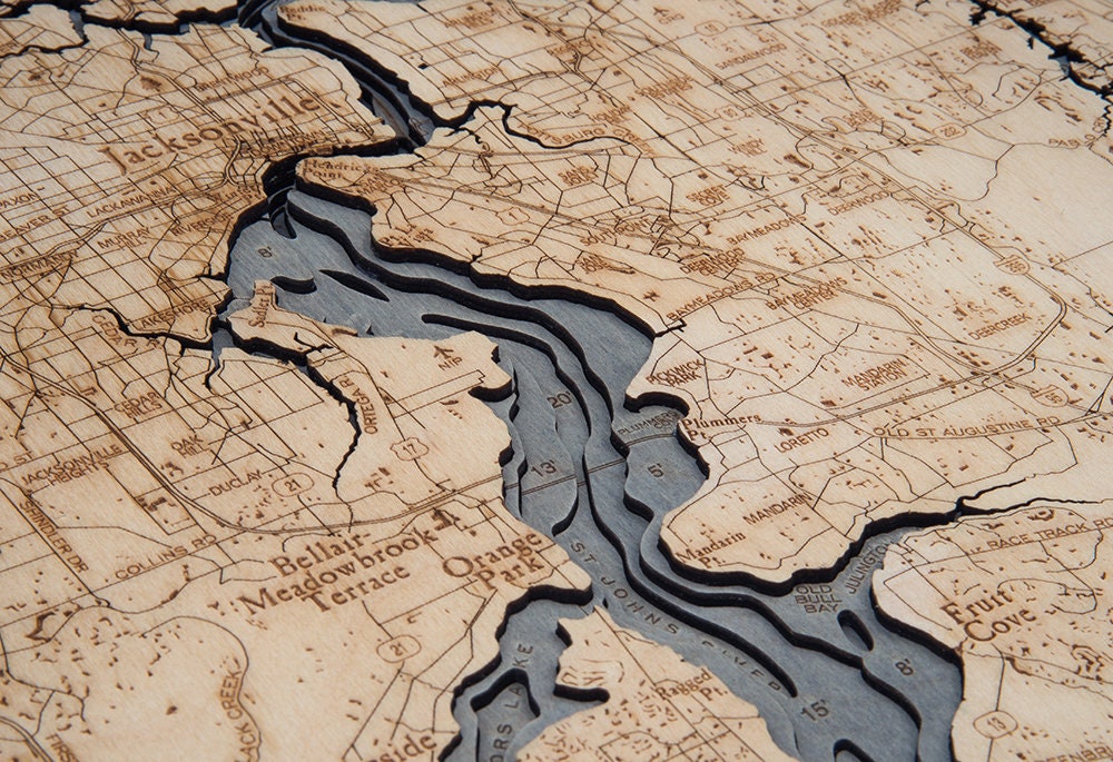Jacksonville, Florida 3D layered wood map in laser-cut Baltic birch, shown framed against a light wall