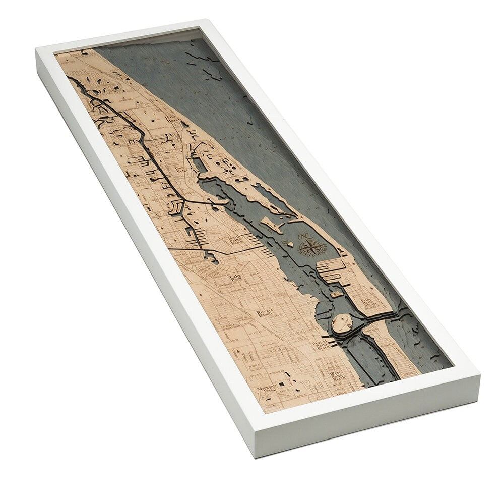 Juno Beach, Florida 3D layered wood map in laser-cut Baltic birch, shown framed against a light wall
