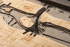 Juno Beach, Florida 3D layered wood map in laser-cut Baltic birch, shown framed against a light wall