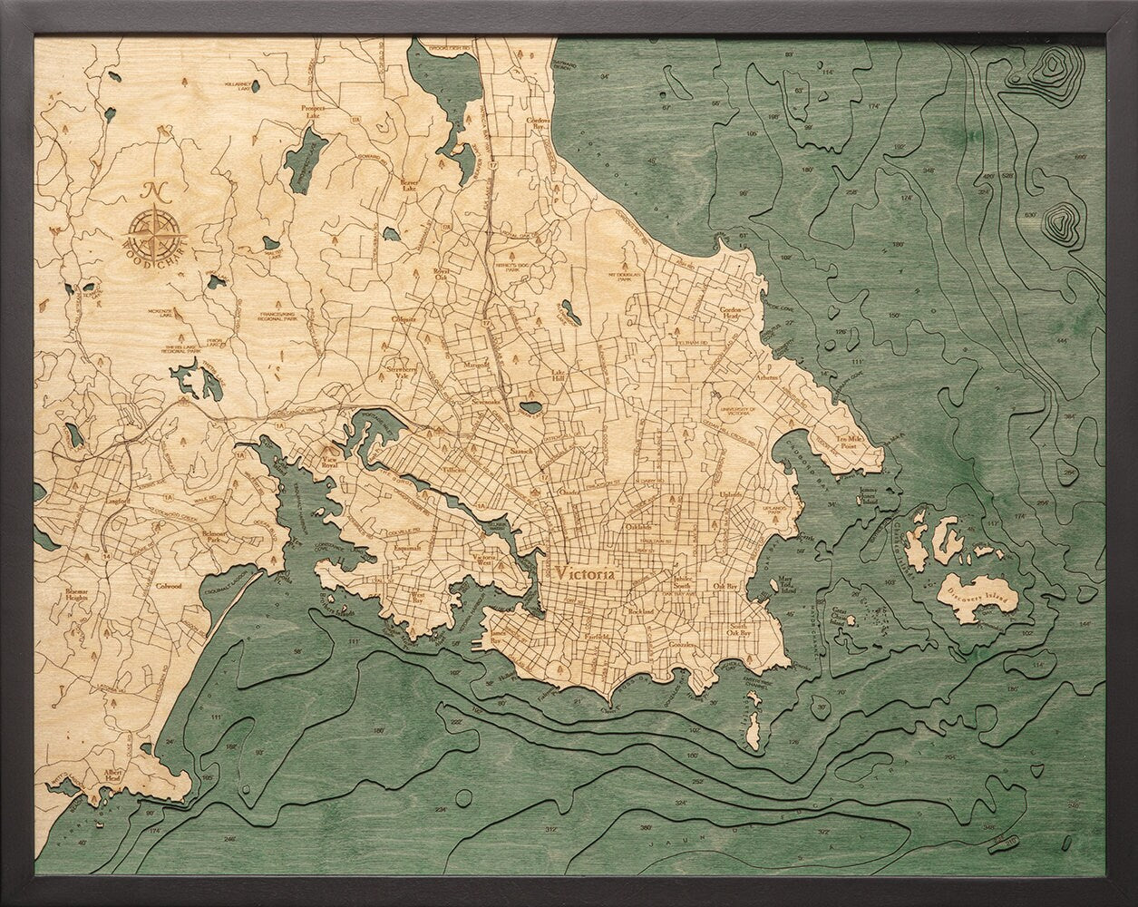 Victoria, British Columbia 3D layered wood map in laser-cut Baltic birch, shown framed against a light wall