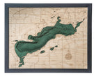 Green Lake, Wisconsin 3D layered wood map in laser-cut Baltic birch, shown framed against a light wall