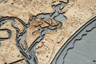 Amelia Island, Florida 3D layered wood map in laser-cut Baltic birch, shown framed against a light wall