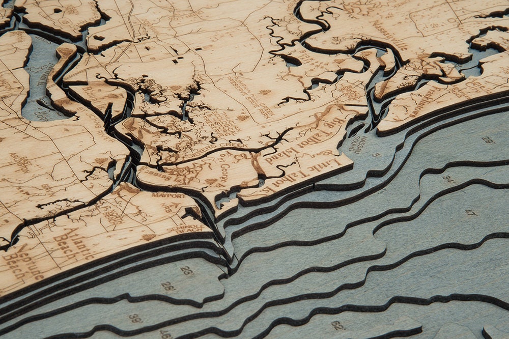Jacksonville, Florida 3D layered wood map in laser-cut Baltic birch, shown framed against a light wall
