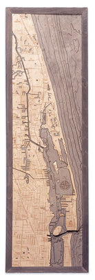 Juno Beach, Florida 3D layered wood map in laser-cut Baltic birch, shown framed against a light wall