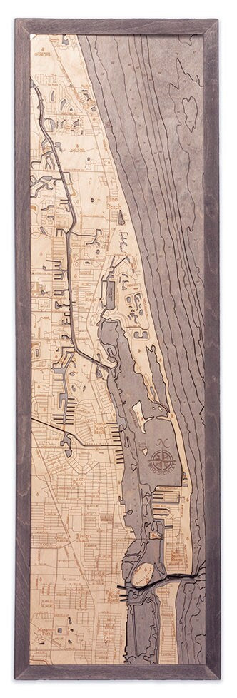 Juno Beach, Florida 3D layered wood map in laser-cut Baltic birch, shown framed against a light wall