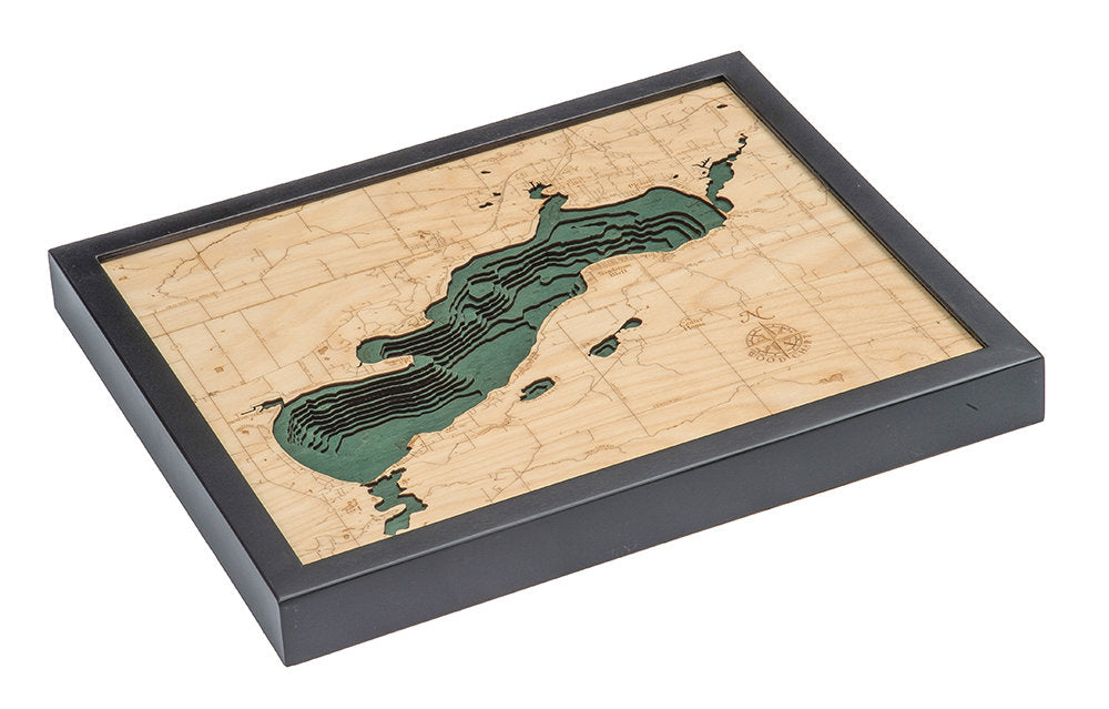 Green Lake, Wisconsin 3D layered wood map in laser-cut Baltic birch, shown framed against a light wall