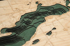 Green Lake, Wisconsin 3D layered wood map in laser-cut Baltic birch, shown framed against a light wall