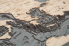 Mediterranean Sea 3D layered wood map in laser-cut Baltic birch, shown framed against a light wall
