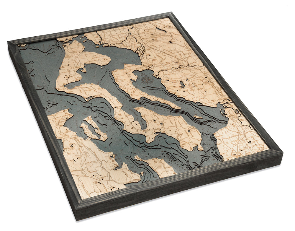 Whidbey & Camano Islands, Washington 3D layered wood map in laser-cut Baltic birch, shown framed against a light wall