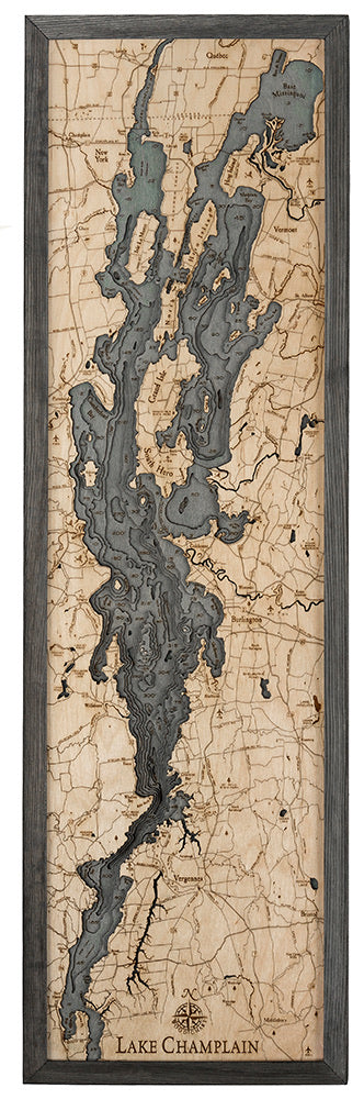 Lake Champlain 3D layered wood map in laser-cut Baltic birch, shown framed against a light wall