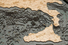 Italy 3D layered wood map in laser-cut Baltic birch, shown framed against a light wall