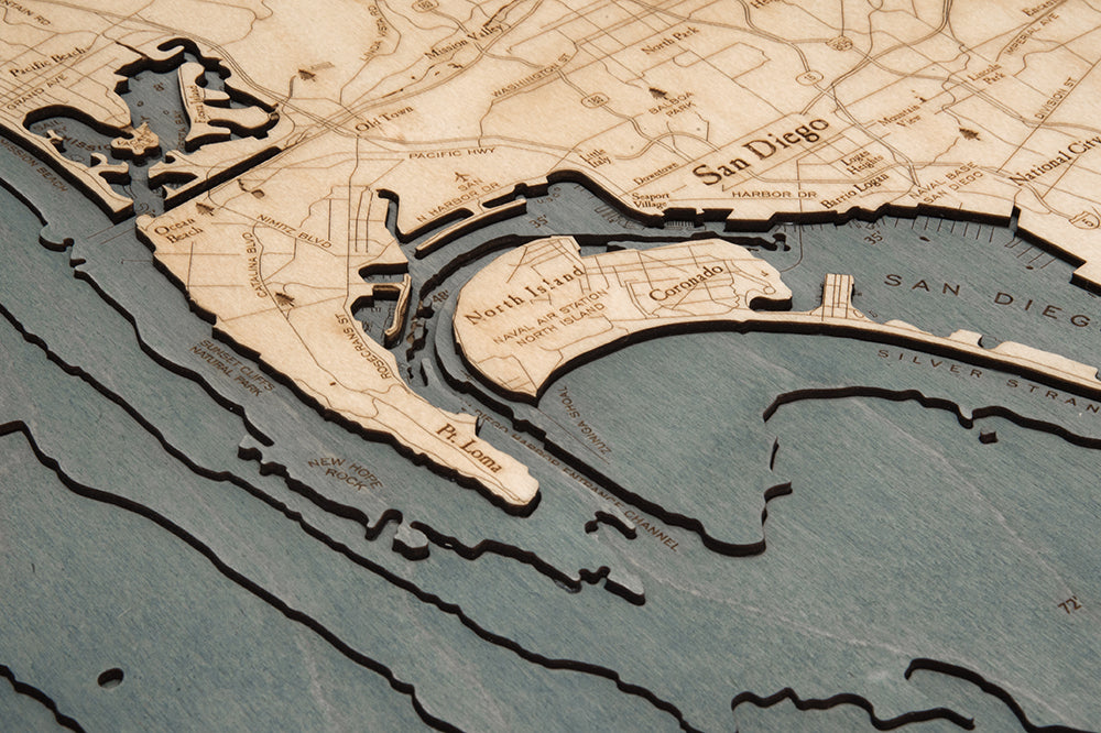San Diego, California 3D layered wood map in laser-cut Baltic birch, shown framed against a light wall