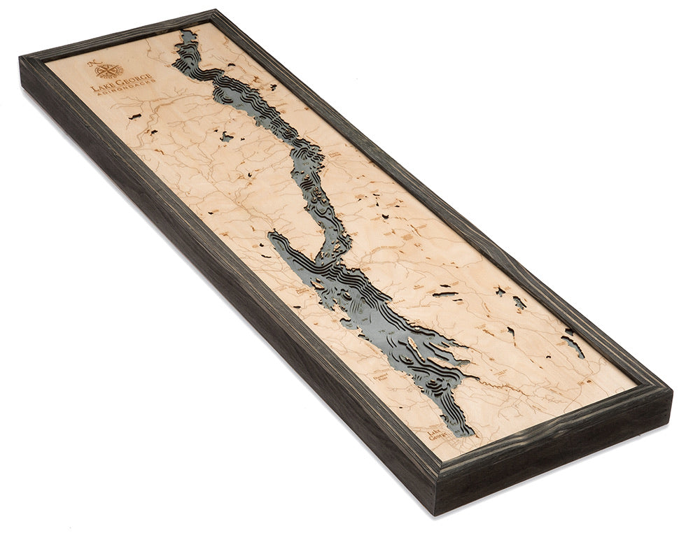 Lake George, New York 3D layered wood map in laser-cut Baltic birch, shown framed against a light wall