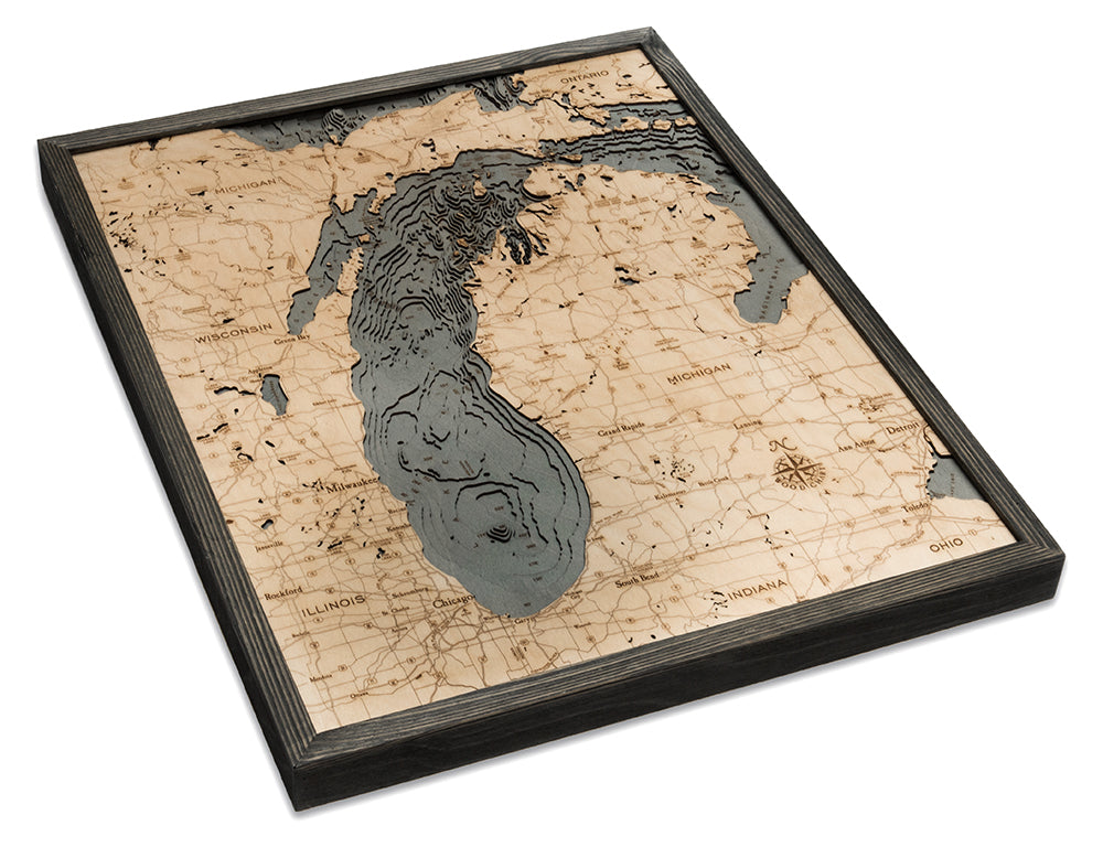 Lake Michigan 3D layered wood map in laser-cut Baltic birch, shown framed against a light wall