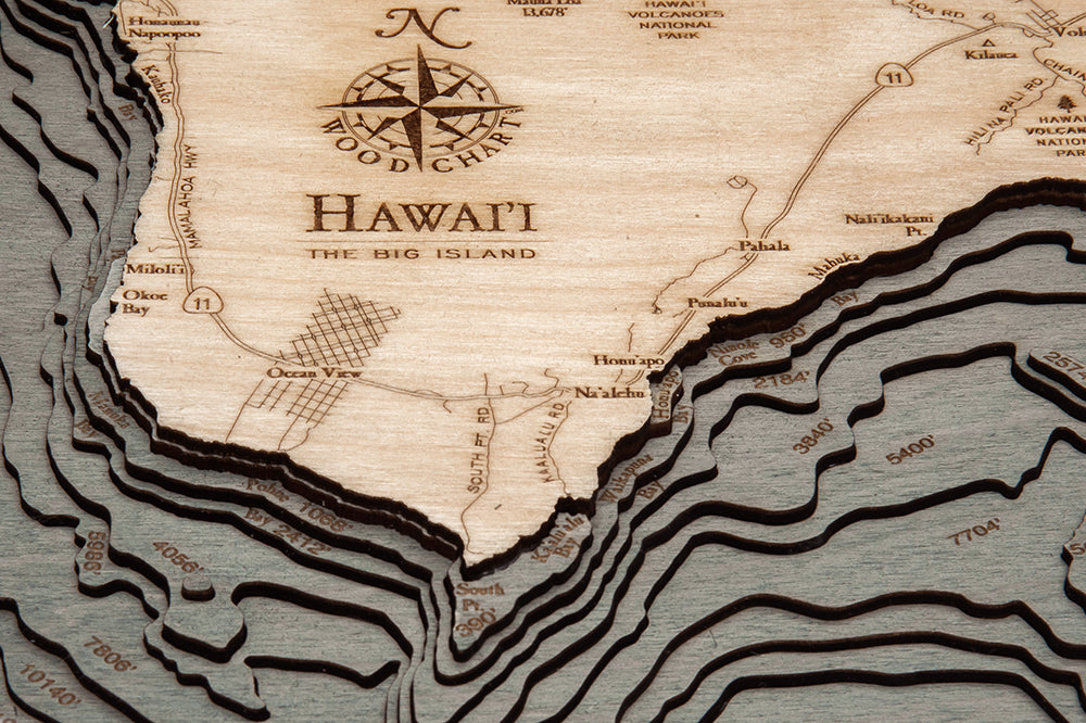 The Big Island, Hawaii 3D layered wood map in laser-cut Baltic birch, shown framed against a light wall