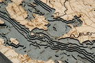 Lake Champlain 3D layered wood map in laser-cut Baltic birch, shown framed against a light wall
