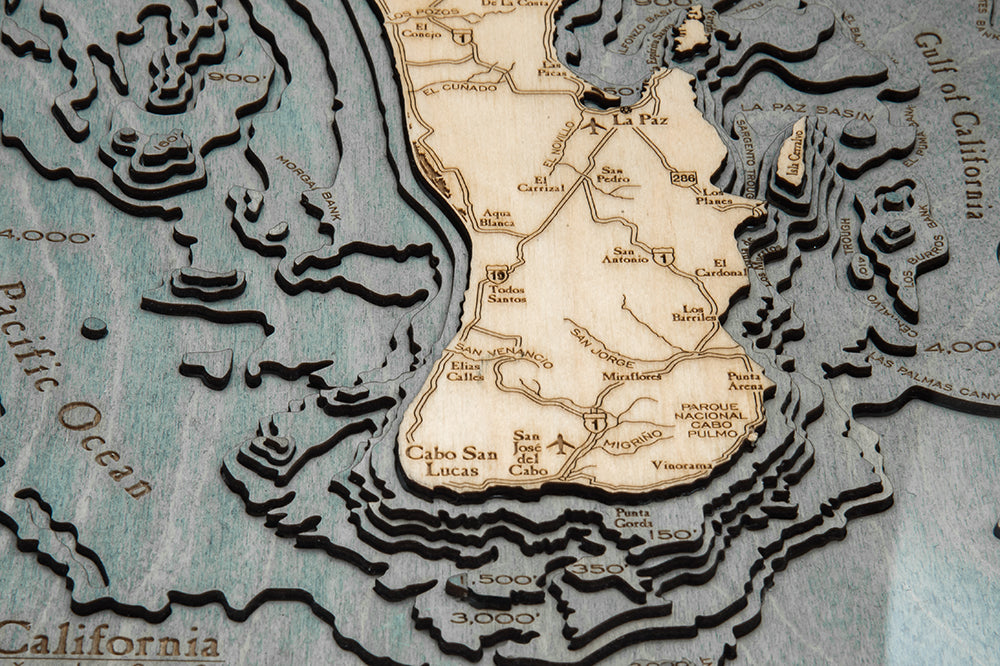 Baja California, Mexico 3D layered wood map in laser-cut Baltic birch, shown framed against a light wall
