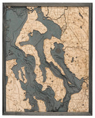 Whidbey & Camano Islands, Washington 3D layered wood map in laser-cut Baltic birch, shown framed against a light wall
