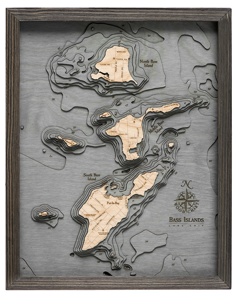 Put-in-Bay, Ohio 3D layered wood map in laser-cut Baltic birch, shown framed against a light wall