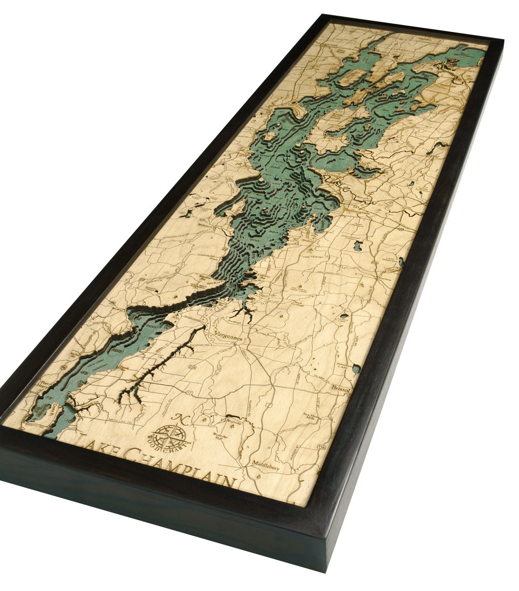 Lake Champlain 3D layered wood map in laser-cut Baltic birch, shown framed against a light wall
